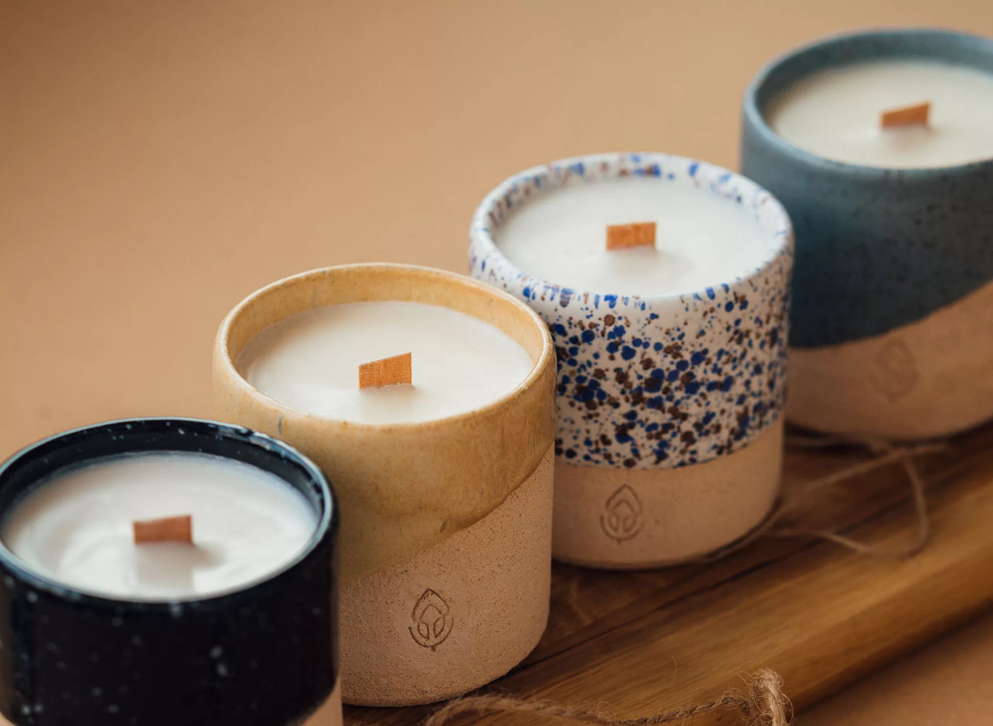 A selection of handmade candles on a wooden base